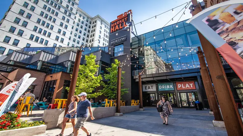 Exterior of Market Hall with string lights and "Eat Drink Play" signage