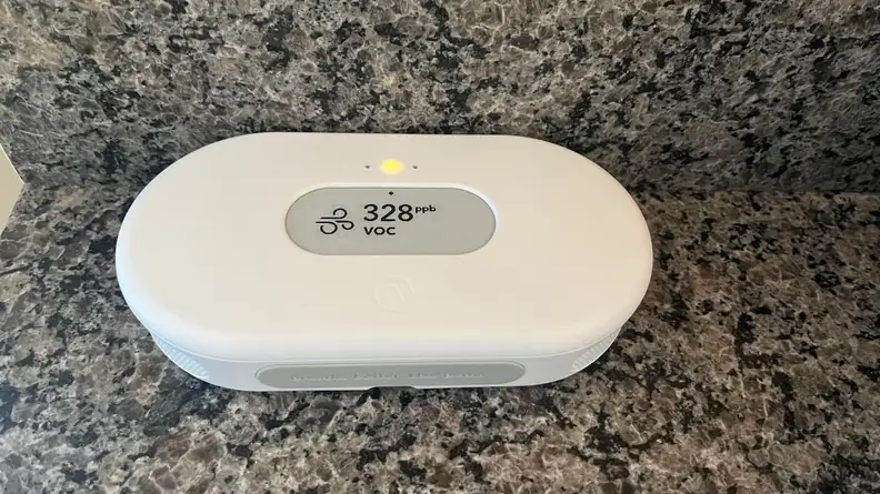 The View of Airthings View Plus on top of a marble counter with the air quality on screen.