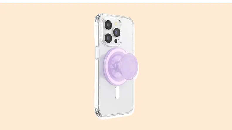 A PopSocket on the back of a smartphone on a vanilla-colored background.