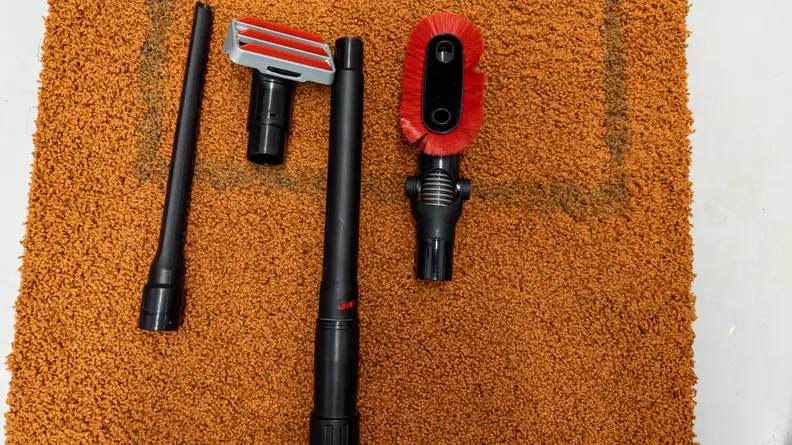 The dusting, upholstery, extender, and crevice tools of the Hoover Swivel XL Pet on carpet
