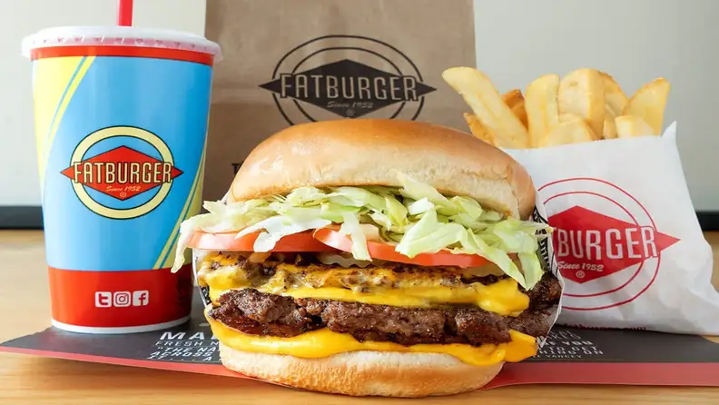 A Fatburger cheeseburger with fries and a drink