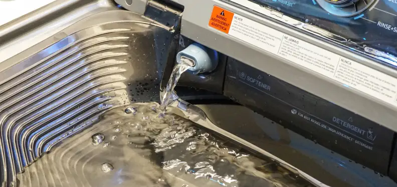 Water pours into the basin, which you can then pour into the main drum after soaking your clothes.