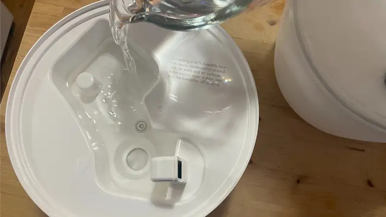 water being poured into a humidifier base
