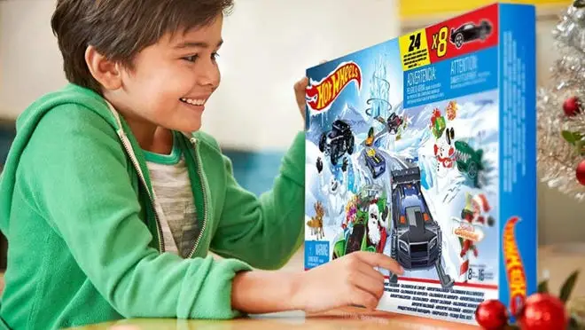 Child playing with Hot Wheels advent calendar.