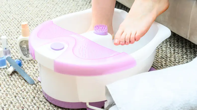 Someone uses a foot spa