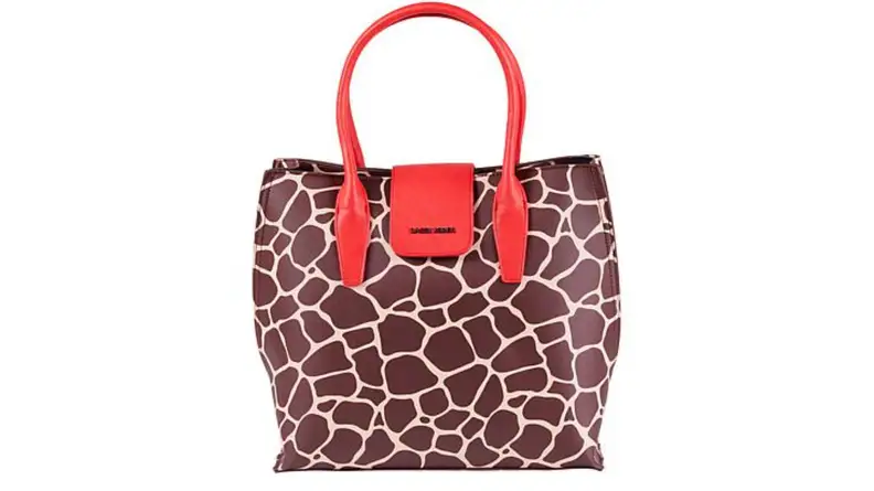 An image of a wide giraffe printed tote with red handles.