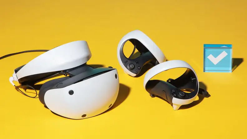 A white VR headset and controllers, the playstation vr2 on a yellow background