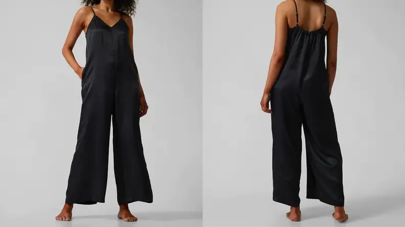 An image of a woman in a black silky romper, next to that same woman in the romper as seen from the back.
