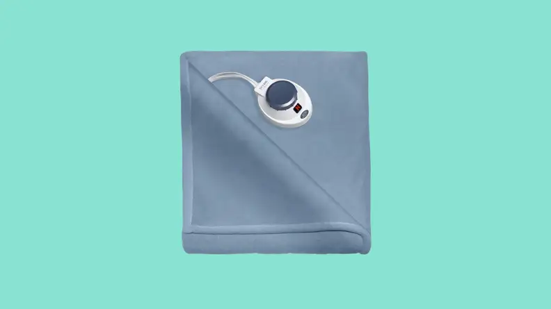 Folded electric blanket against teal background