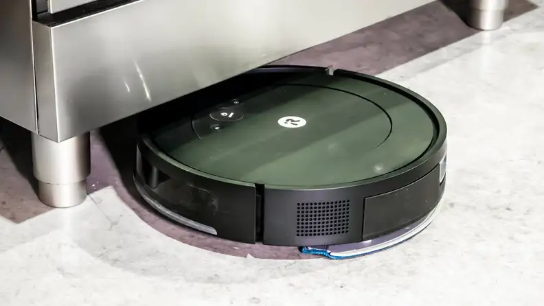 The iRobot Roomba Combo Essential cleaning under an oven.