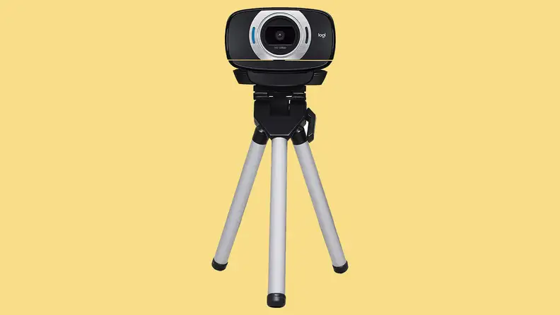 Webcam on tripod with yellow background