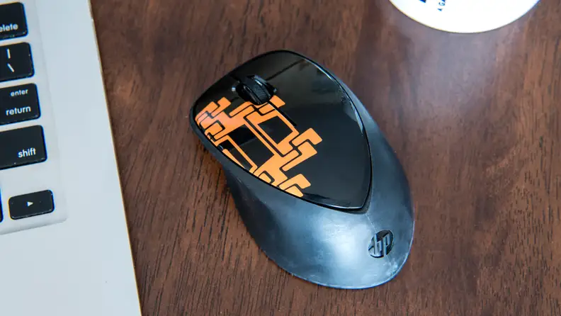Mouse next to laptop on table