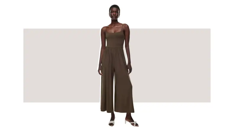 A model wearing a brown jumpsuit.