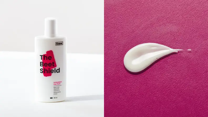Left: A white bottle is labeled "The Beet Shield Antioxidant Day Fluid." Right: A bit of the white fluid has been squeezed onto a magenta surface.