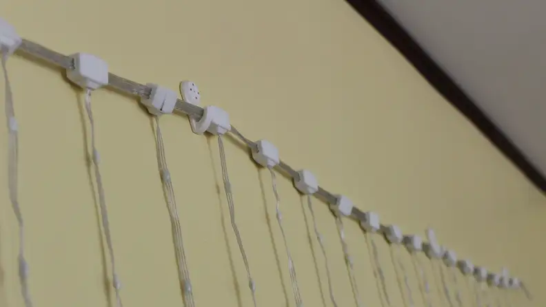 Close-up of the Govee Curtain lights being hung up by wall hooks.