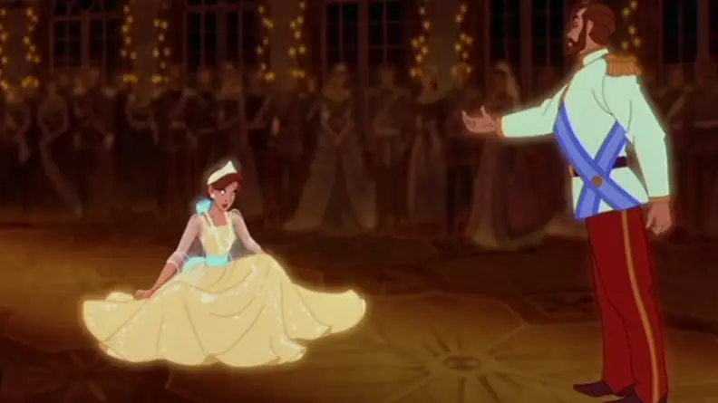 A still from "Anastasia" featuring Anya kneeling before her father in a memory.