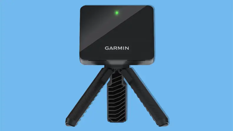 Garmin Approach R10 portable golf launch monitor on a blue background.