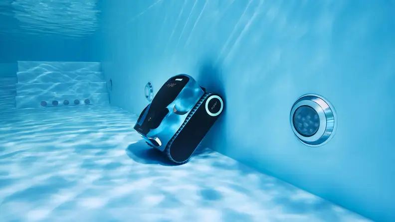 Piper Scuba X1 Pro Max cleaning the walls and floor of a pool, shot from underwater