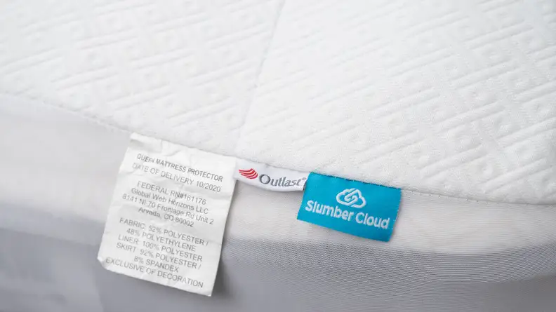 A closeup of a waterproof mattress protector and its product tags