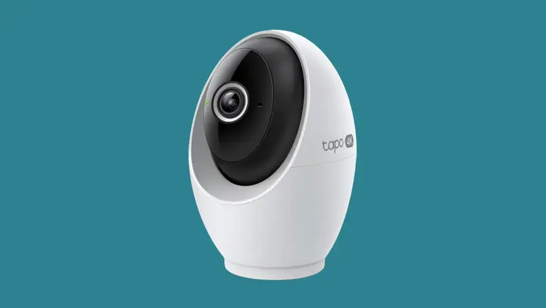 A white security camera on a teal background