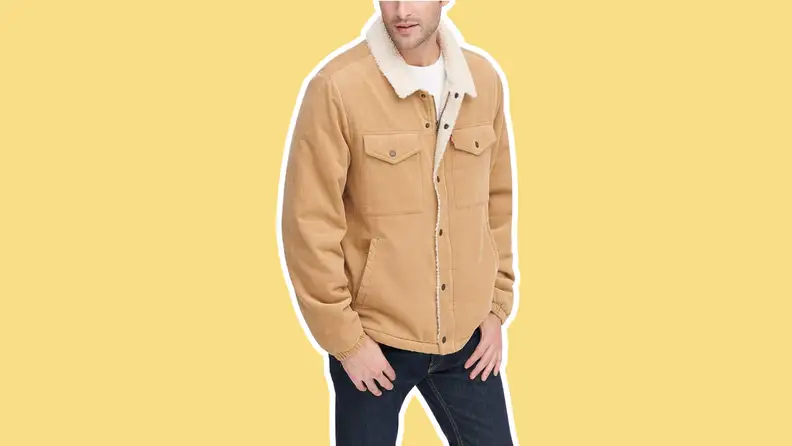 A man wearing the Levi's Men's Corduroy Sherpa Trucker Jacket in the color tan.