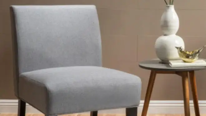 A gray chair sits in a beige living room.