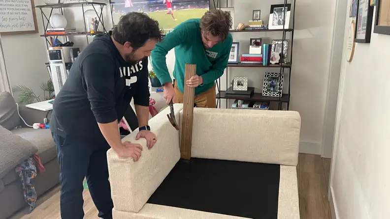 Two men building the sofa.