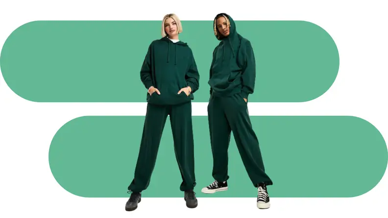 Two models wearing green matching sweatsuits.