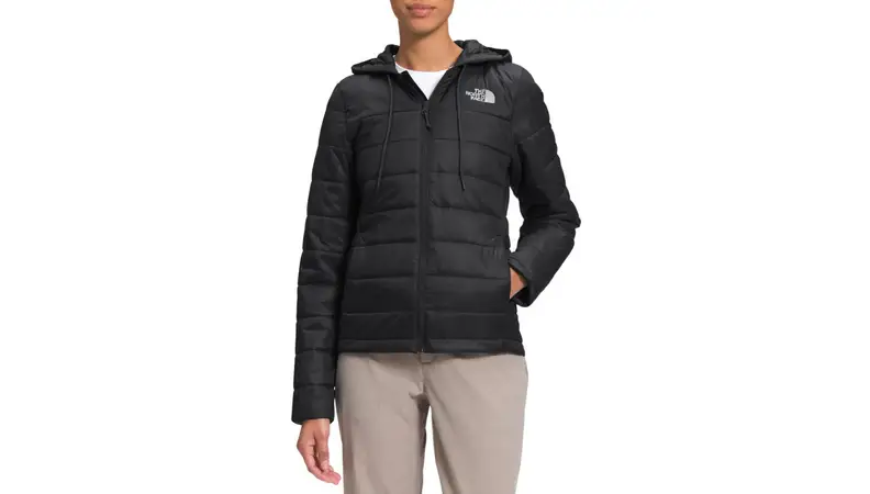A model wearing a black, hooded, puffy, North Face jacket.