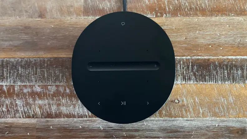 A top down view of the Sonos Era 100 speaker on a wooden floor.