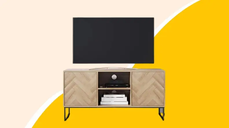 A wooden television console with television on top.