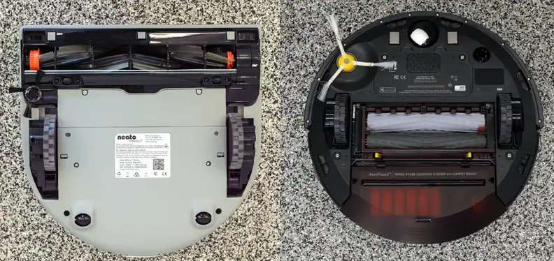 The Neato's D shape lets it clean closer to walls than the iRobot.