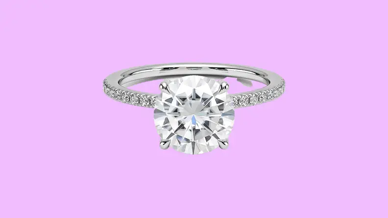 Photo of the Brilliant Earth Moissanite Viviana Half-Coverage Lab Diamond Ring against a purple background.