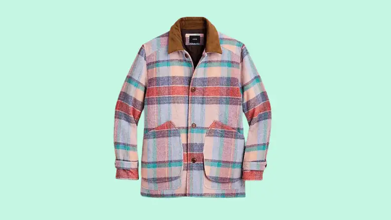 A pink plaid wool coat against a green background.