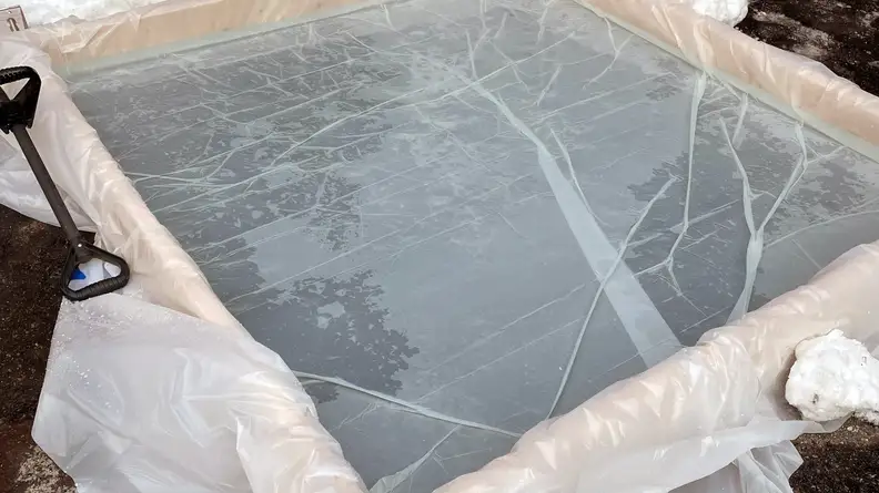 A small ice rink made of wood and plastic sheeting