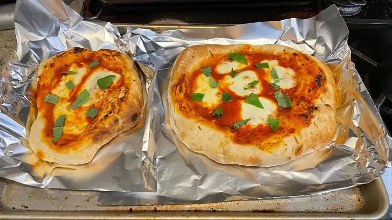 Two pizzas evenly cooked.