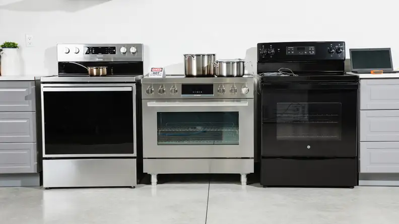 Three different range's side-by-side in the colors black and silver, being tested by Reviewed Kitchen editors.