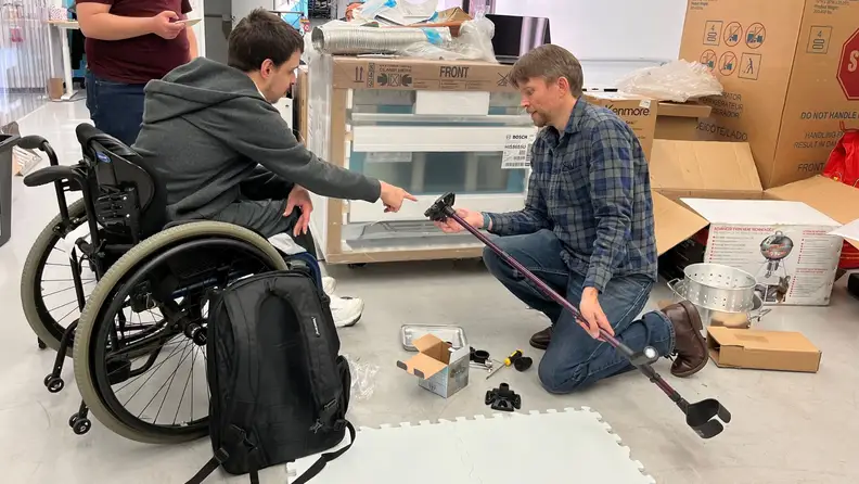 tester holding crutches to measure grip