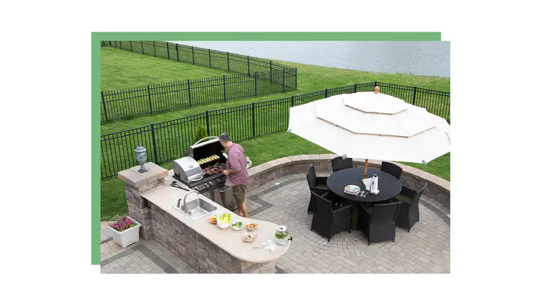 A person grills outside on a patio.