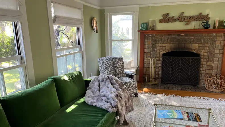 A faux fur blanket on a green velvet couch