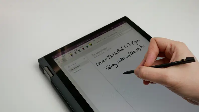 Person using stylus pen to write on the touchscreen of the Lenovo ThinkPad L13 Yoga Gen 4 laptop.