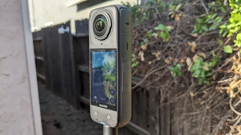 A side view of screen and camera on the Insta360 X4 Action Camera outdoors.