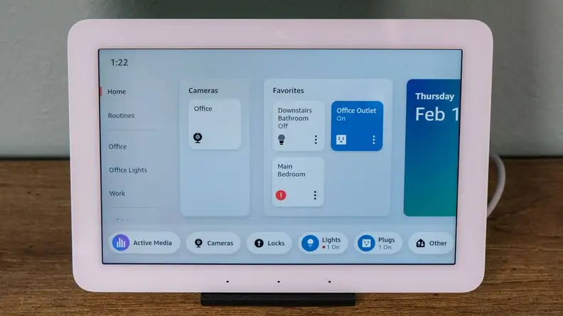 The Amazon Echo Hub with the screen on showing smart devices controls and sitting on a wood table.