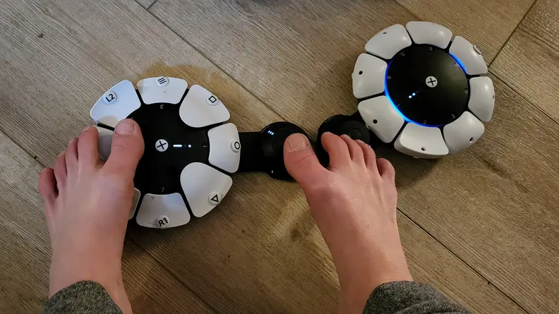Feet pushing controller buttons on two Access Controllers.