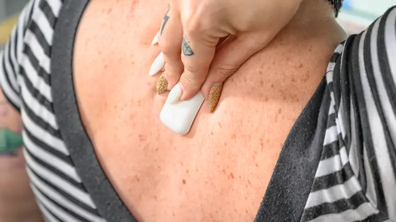 After applying an adhesive strip, you can mount the Upright Go 2 on your back.