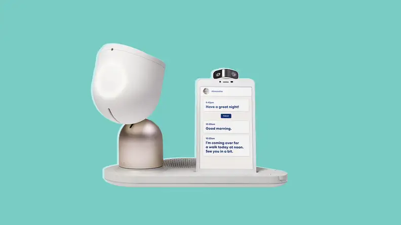 The ElliQ device with a smartphone attached in front of a background.