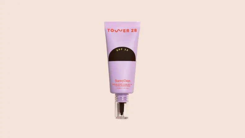 The Tower 28 Sunscreen in front of a background.