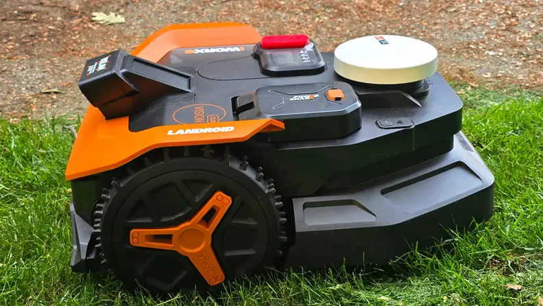 Side profile of Worx Landroid WR340 robot lawn mower on green grass.