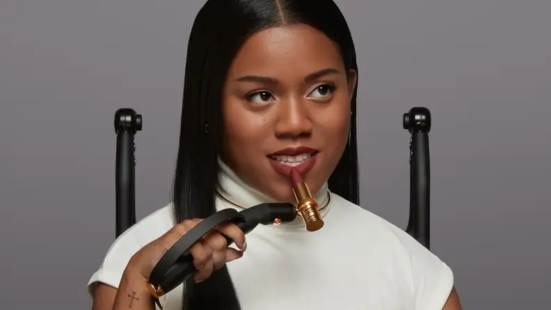 Person applies lipstick using an assistive makeup application device