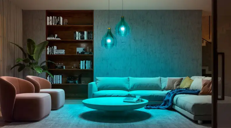 A well-decorated living room with two pendant lights featuring blue lights
